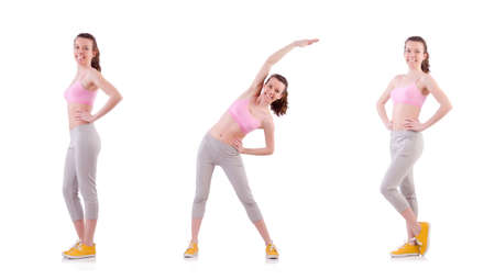 Young woman doing exercises on whiteの写真素材