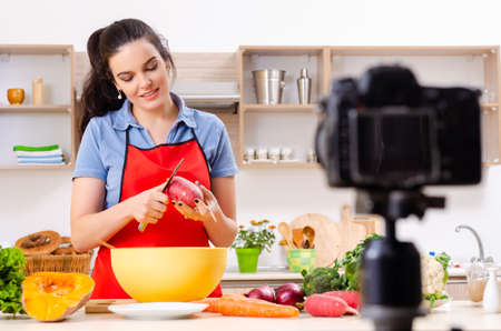 Young female vegetarian recording video for her blogの写真素材