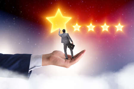 Businessman held on hand reaching out for starsの写真素材