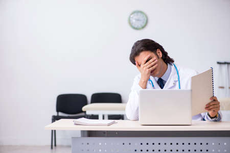 Young doctor being tired after night shiftの写真素材
