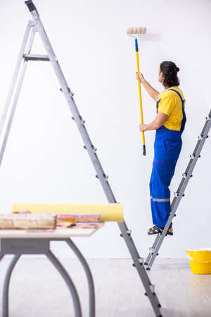 Young man contractor doing renovation at homeの写真素材