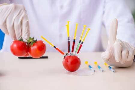 Male nutrition expert testing food products in lab
