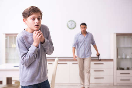 Father beating and punishing his sonの写真素材