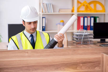Young male architect working in the office