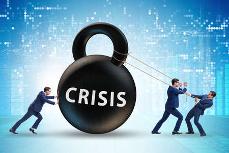 Businessman in crisis concept pulling kettlebellの写真素材