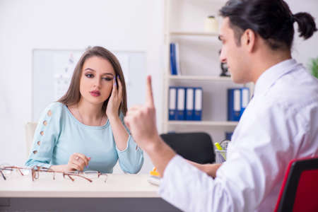 Young woman visiting male doctor oculist