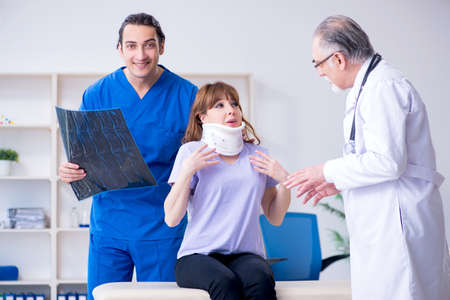 Two doctors examining young womanの写真素材
