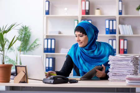 Female employee in hijab working in the officeの写真素材