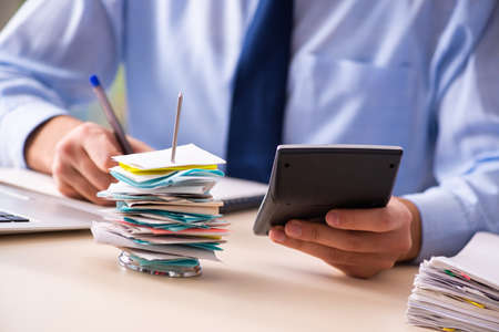 Young male employee in budget planning concept