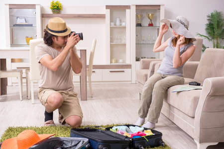 Young couple preparing for tripの写真素材
