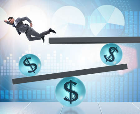 Businessman balancing in financial dollar conceptの写真素材