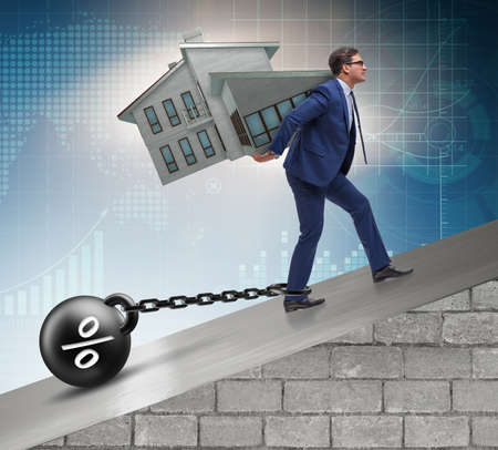 Businessman in mortgage debt financing conceptの写真素材