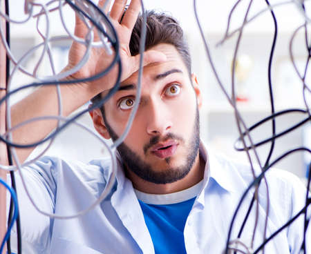 Computer repairman working on repairing network in IT workshop