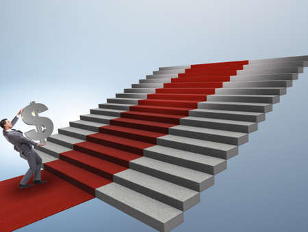 Young businessman climbing stairs and red carpet