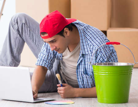 Young painter contractor choosing colors for home renovationの写真素材