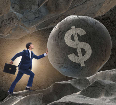 Businessman pushing dollar sign in business conceptの写真素材