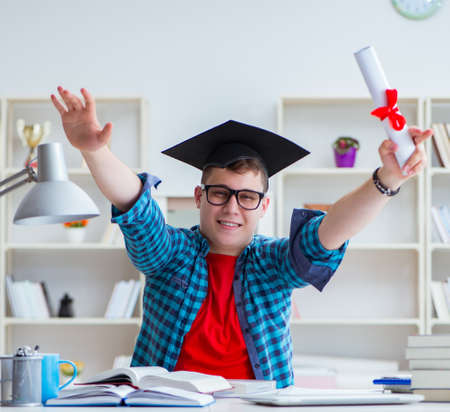 Young teenager preparing for exams studying at a desk indoorsの写真素材
