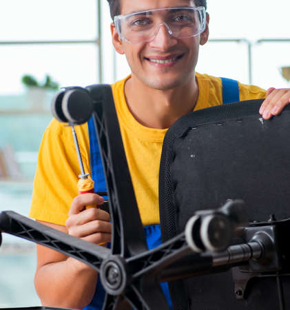 Furniture repairman working on repairing the chairの写真素材