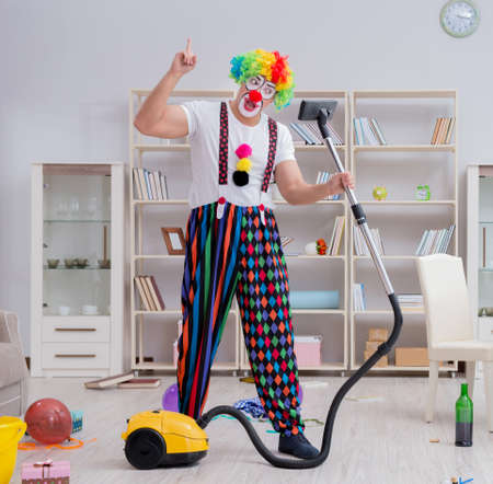 Funny clown doing cleaning at homeの写真素材