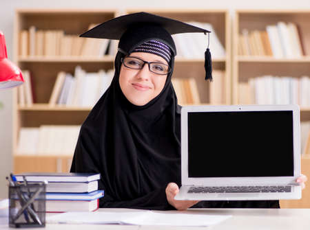 Muslim girl in hijab studying preparing for examsの写真素材