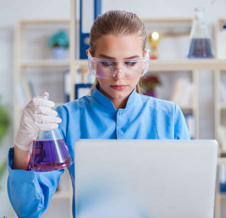 Female scientist researcher conducting an experiment in a laboraの写真素材