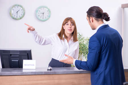 Young businessman at hotel receptionの写真素材