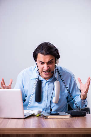 Call center operator working at his deskの写真素材