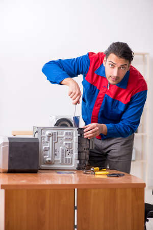 Young engineer repairing musical hi-fi systemの写真素材