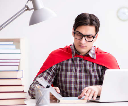 Super hero student with a laptop studying preparing for examsの写真素材