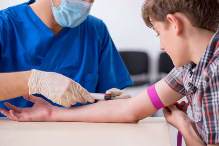 Young boy visiting doctor in hospitalの写真素材