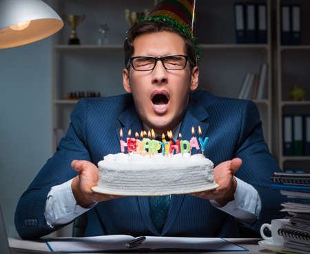 Man celebrating birthday in the officeの写真素材