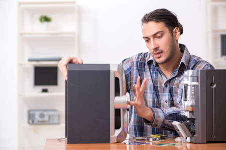 Young engineer repairing musical hi-fi system