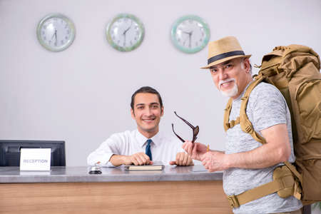 Backpacker at the hotel receptionの写真素材