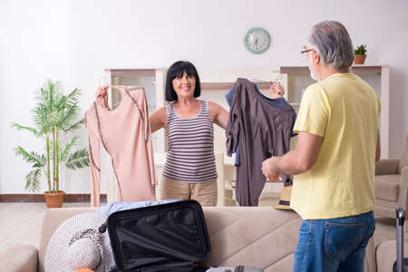 Old couple preparing for vacation travelの写真素材