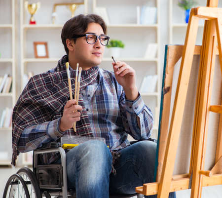 Disabled artist painting picture in studioの写真素材