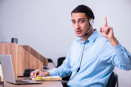 Call center operator working at his desk