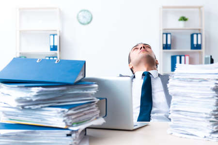 Businessman with heavy paperwork workload