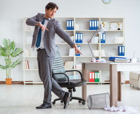 Businessman having fun taking a break in the office at workの写真素材