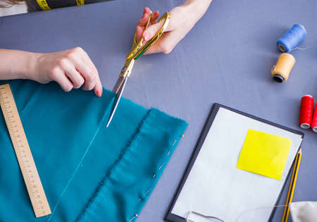 Woman tailor working on a clothing sewing stitching measuring faの写真素材