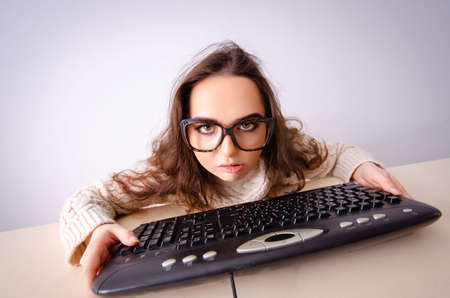 Funny nerd girl working on computer