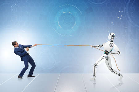 Competition between humans and robots in tug of war conceptの写真素材