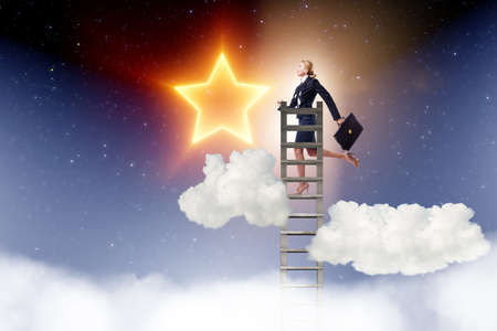 Businesswoman reaching out for stars in success concept