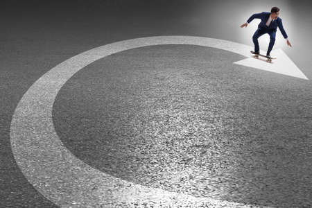 Businessman riding skateboard on financial graphの写真素材