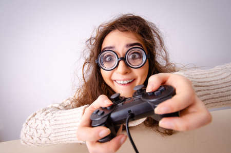 Funny nerd girl playing gamesの写真素材