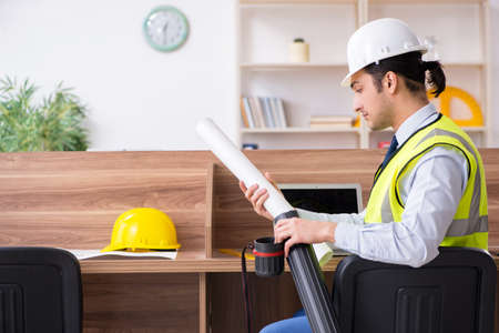 Young male architect working in the office
