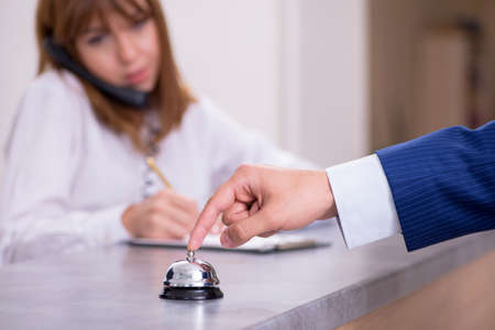 Young woman receptionist at hotel reception