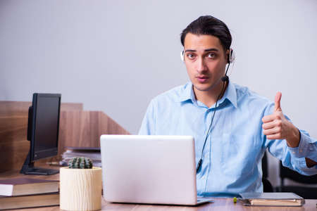 Call center operator working at his desk