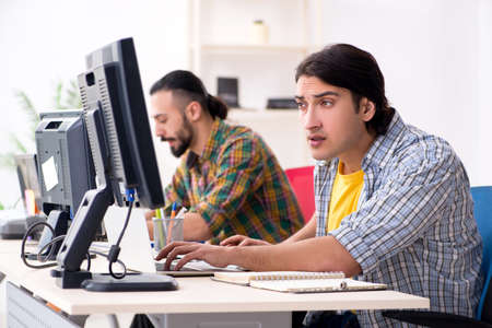 Two it specialists working in the officeの写真素材