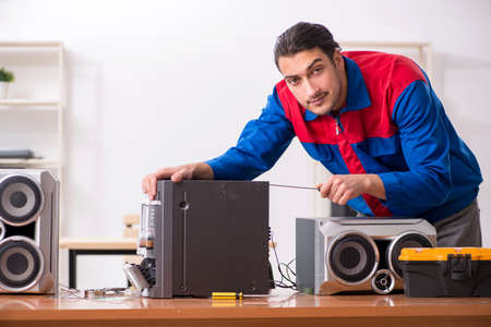 Young engineer repairing musical hi-fi systemの写真素材
