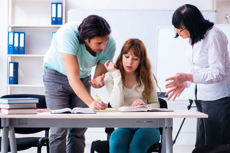Old teacher and students in the classroomの写真素材